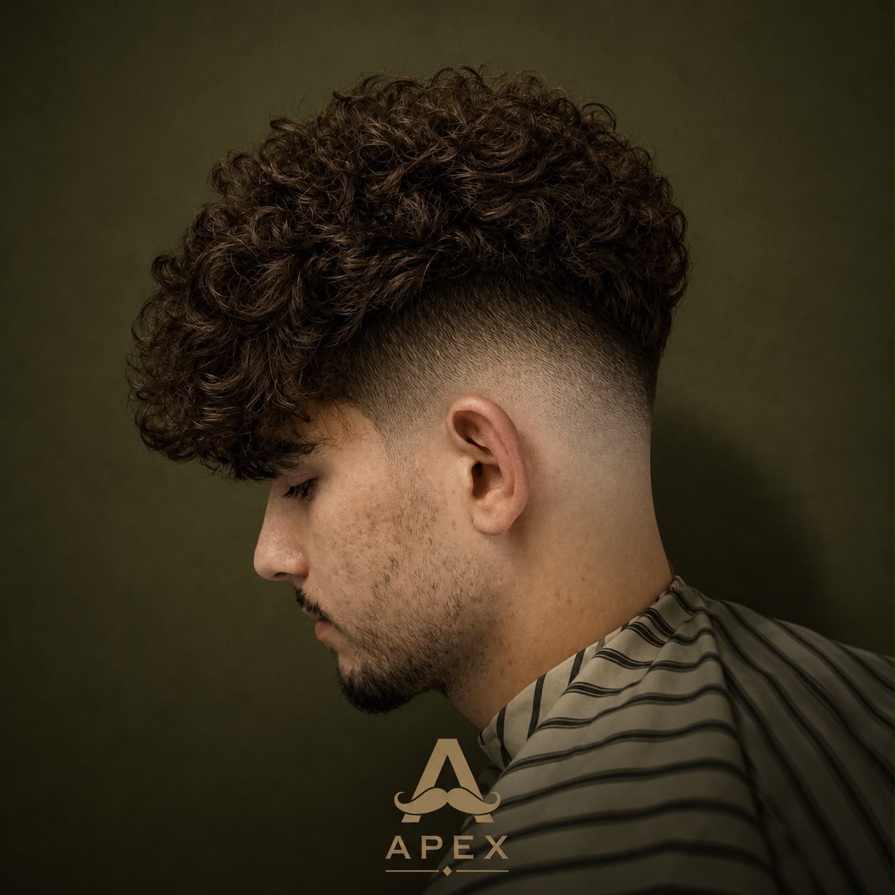 Haircut work — curly top with a mid taper fade
